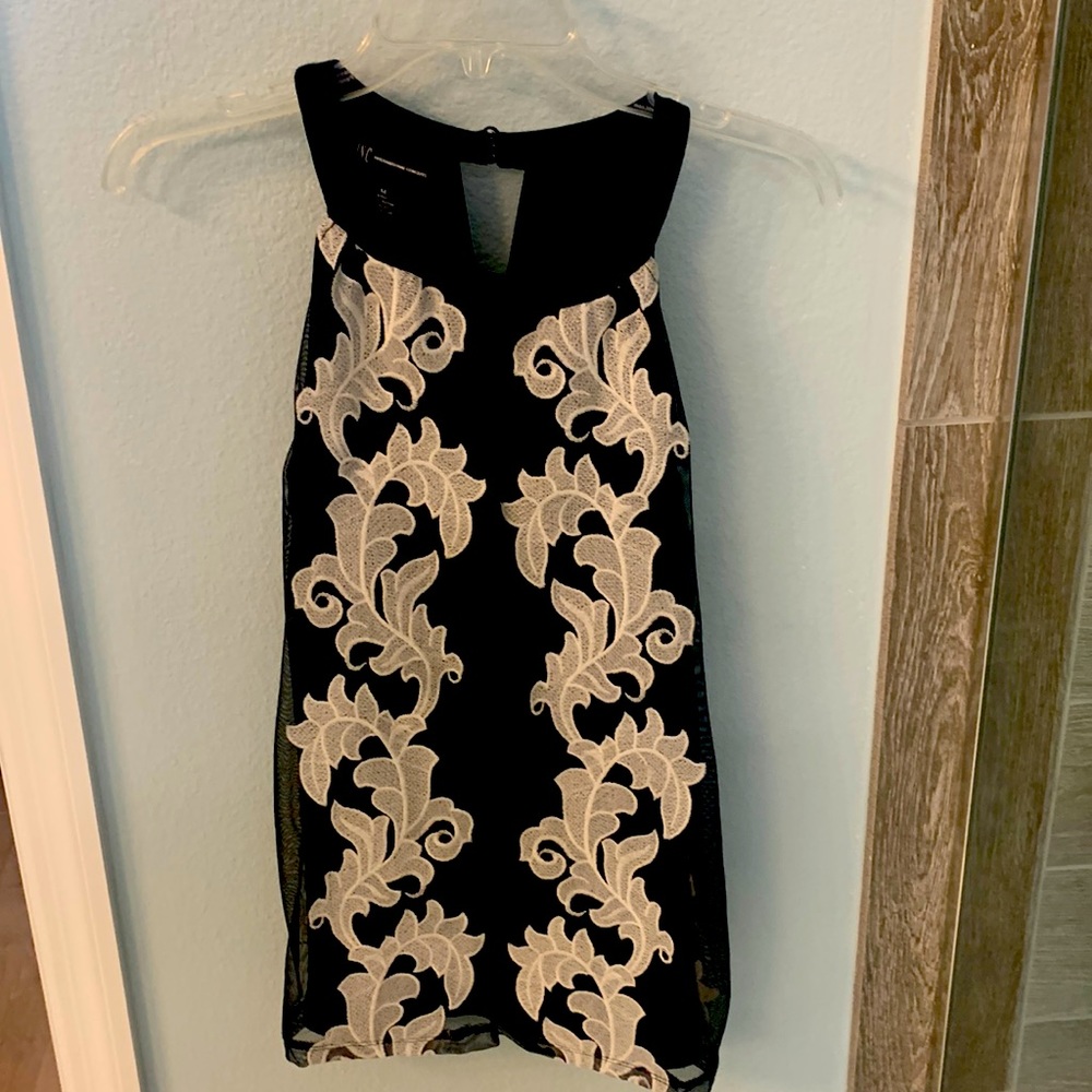 Black sleeveless top with cream floral design-shoulder flattering cut.